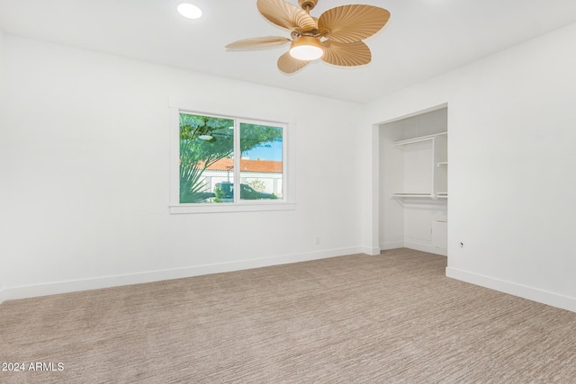 unfurnished bedroom with carpet, a closet, and ceiling fan