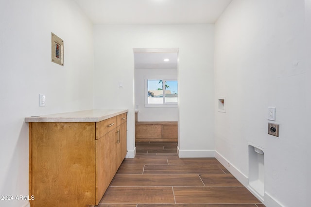 clothes washing area with washer hookup, electric dryer hookup, and dark hardwood / wood-style flooring