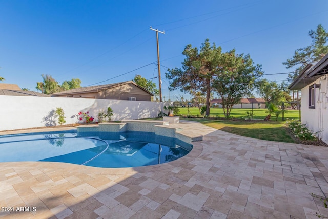 view of pool featuring a yard and a patio