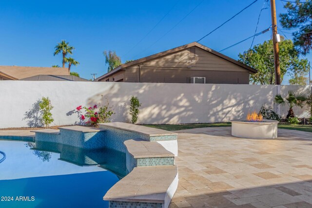 view of pool featuring a patio area and an outdoor fire pit