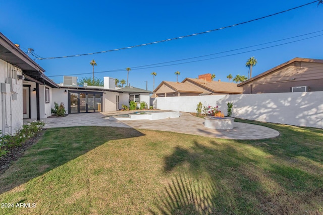 view of yard with a fenced in pool and a patio