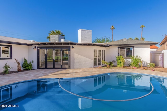 view of pool with a patio area and french doors