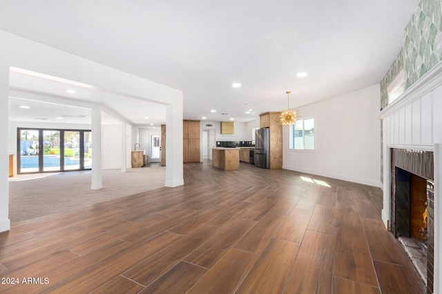 unfurnished living room featuring a fireplace and dark hardwood / wood-style flooring