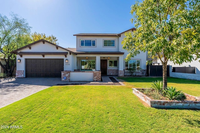 view of front facade with a garage and a front lawn