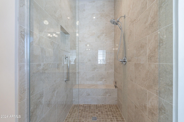 bathroom with a tile shower