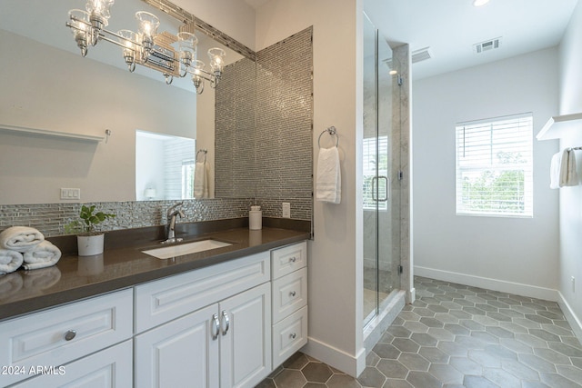 bathroom with walk in shower, vanity, tile patterned flooring, and decorative backsplash