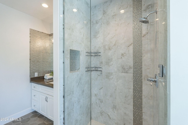 bathroom featuring tile patterned floors, vanity, and a shower with shower door