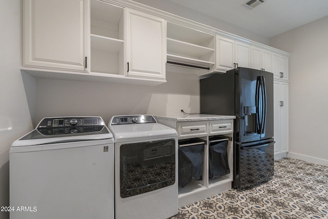 clothes washing area with cabinets and independent washer and dryer