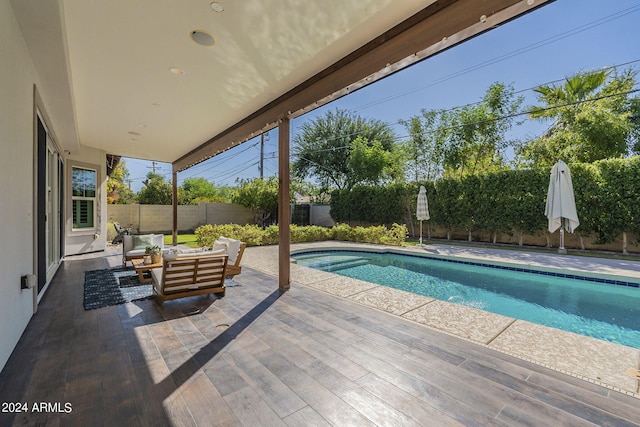 view of pool with outdoor lounge area and a patio area