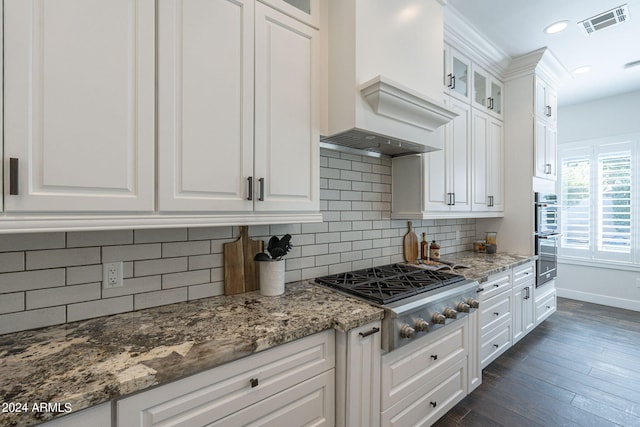 kitchen featuring appliances with stainless steel finishes, decorative backsplash, and white cabinets