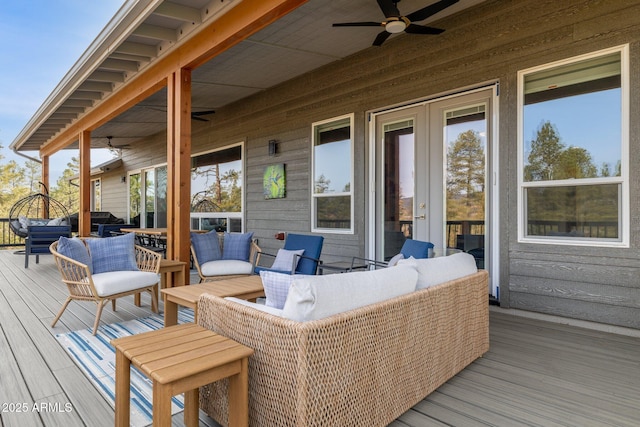 wooden deck with outdoor lounge area and ceiling fan