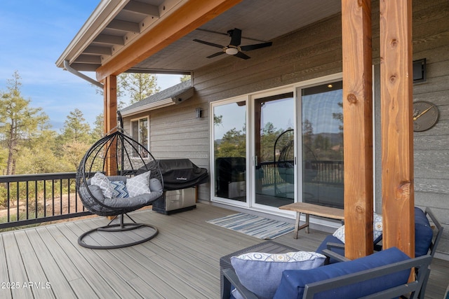 wooden terrace featuring ceiling fan and grilling area