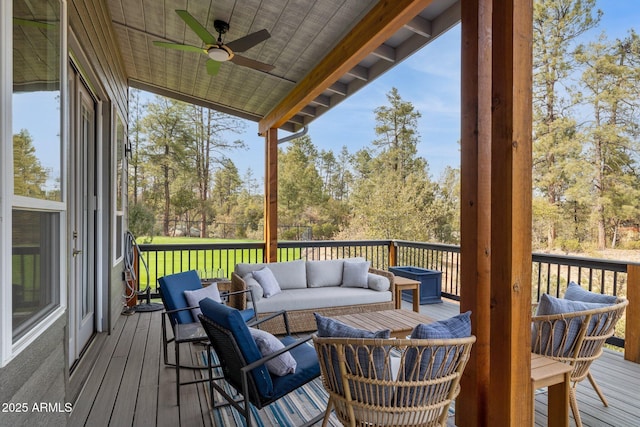 wooden terrace featuring outdoor lounge area and ceiling fan