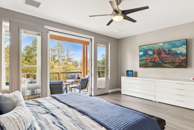 bedroom with wood-type flooring, access to outside, and ceiling fan