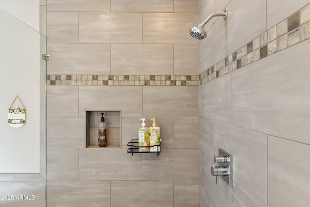 interior details featuring tiled shower