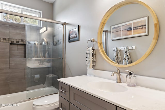 full bathroom with vanity, enclosed tub / shower combo, and toilet