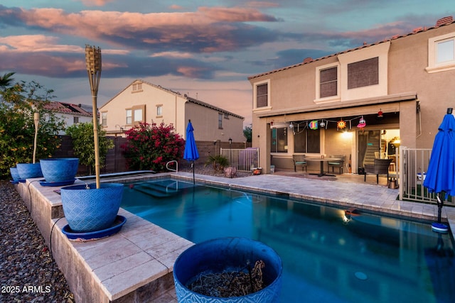 654 E Taylor Trl, San Tan Valley, AZ 85143 - pool at dusk featuring a patio