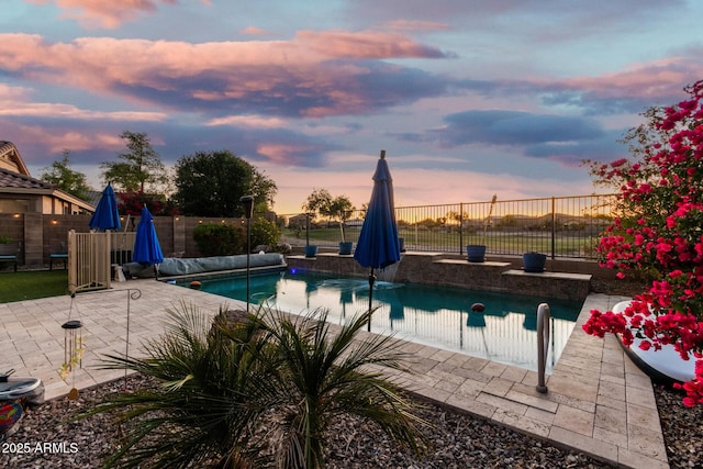 654 E Taylor Trl, San Tan Valley, AZ 85143 - pool at dusk featuring a fenced backyard and a patio area