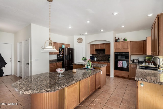 654 E Taylor Trl, San Tan Valley, AZ 85143 - kitchen with black appliances, a sink, light tile patterned floors, a center island, and backsplash