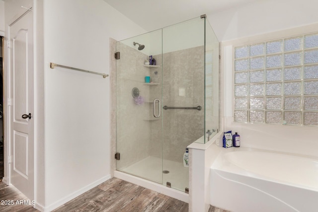 654 E Taylor Trl, San Tan Valley, AZ 85143 - full bathroom featuring a bath, a shower stall, wood finished floors, and baseboards