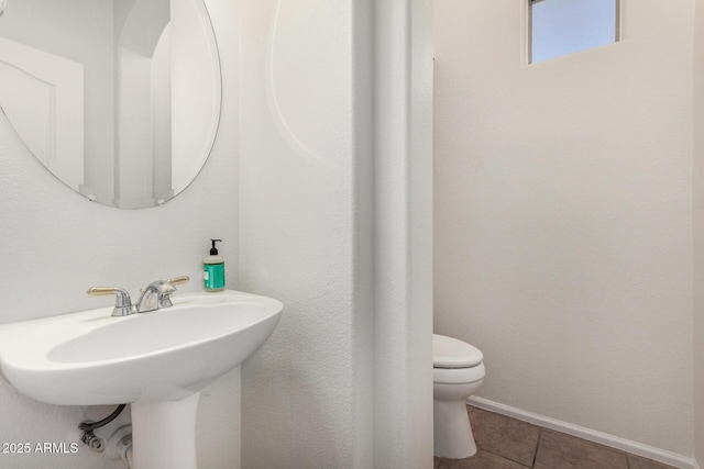 654 E Taylor Trl, San Tan Valley, AZ 85143 - half bathroom with toilet, tile patterned flooring, baseboards, and a sink