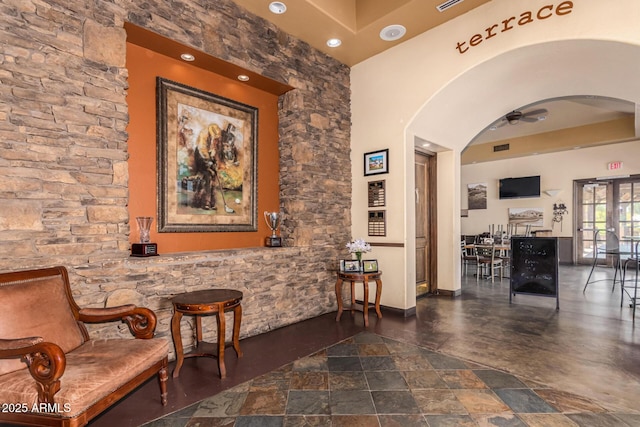 654 E Taylor Trl, San Tan Valley, AZ 85143 - living area with arched walkways, ceiling fan, stone finish floors, and recessed lighting