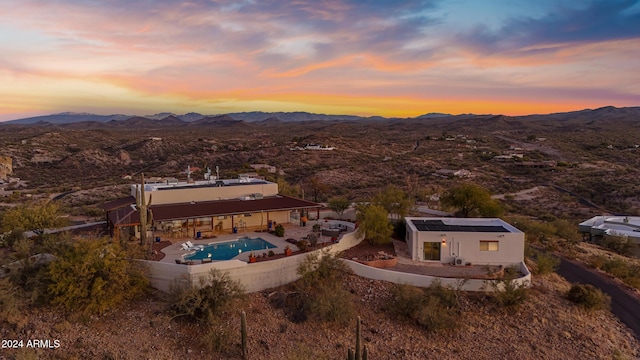 aerial view at dusk featuring a mountain view