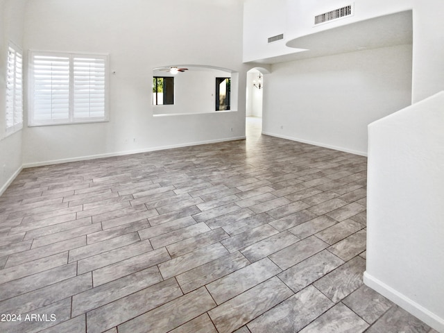 unfurnished living room with light wood-type flooring and ceiling fan