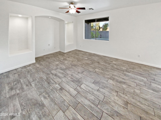 spare room featuring light hardwood / wood-style floors and ceiling fan