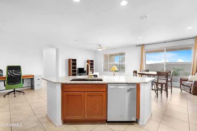 kitchen featuring light stone countertops, ceiling fan, sink, a center island with sink, and dishwasher