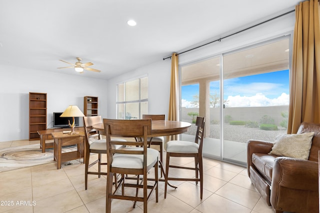 tiled dining area with ceiling fan