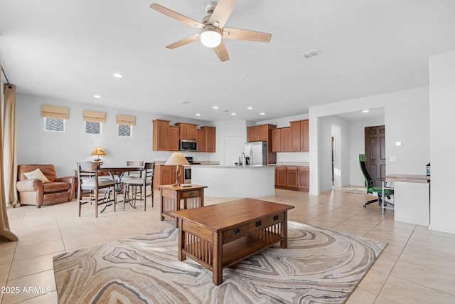 tiled living room featuring ceiling fan