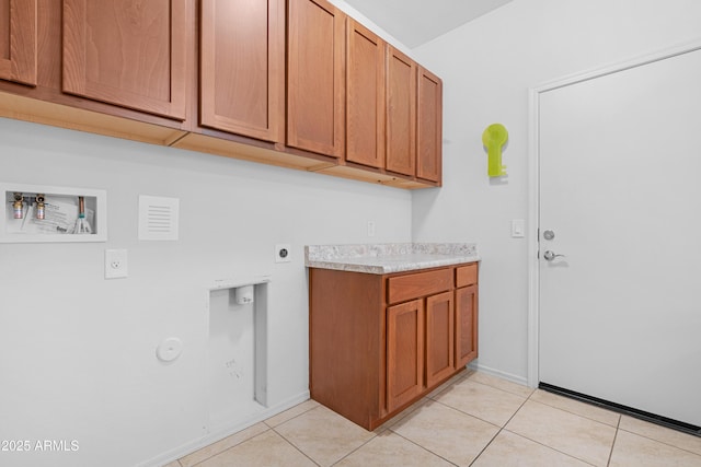 clothes washing area featuring hookup for an electric dryer, washer hookup, cabinets, and light tile patterned flooring