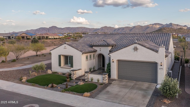 26673 W Ponderosa Ln, Buckeye, AZ 85396 - mediterranean / spanish home featuring driveway, a tile roof, stucco siding, a garage, and a mountain view