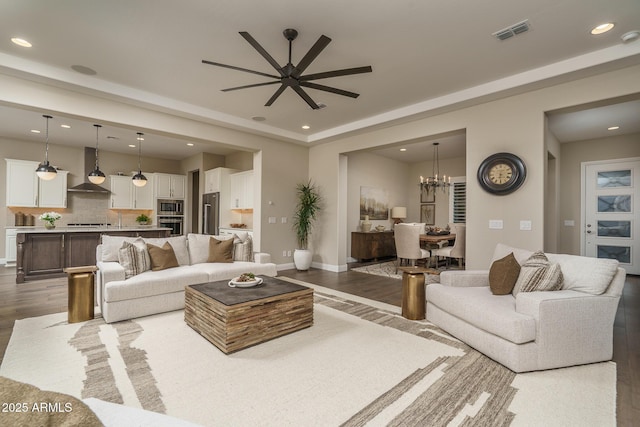 26673 W Ponderosa Ln, Buckeye, AZ 85396 - living area with recessed lighting, ceiling fan with notable chandelier, baseboards, visible vents, and wood finished floors