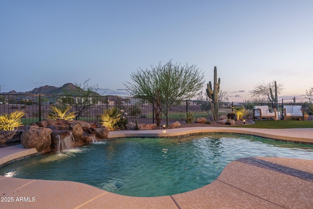 26673 W Ponderosa Ln, Buckeye, AZ 85396 - pool at dusk featuring a fenced in pool and fence