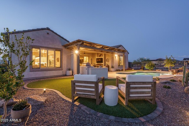 26673 W Ponderosa Ln, Buckeye, AZ 85396 - back of property with a patio area, stucco siding, fence, outdoor lounge area, and an outdoor pool