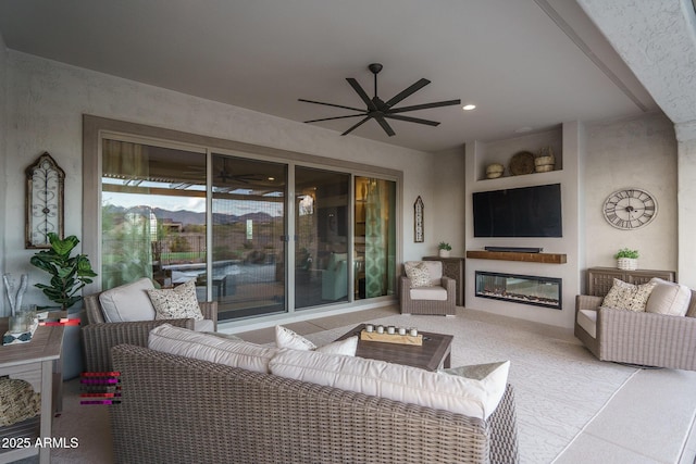 26673 W Ponderosa Ln, Buckeye, AZ 85396 - living area with carpet flooring, a glass covered fireplace, recessed lighting, and a ceiling fan