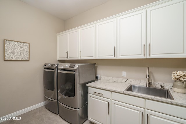 26673 W Ponderosa Ln, Buckeye, AZ 85396 - clothes washing area featuring baseboards, washing machine and dryer, cabinet space, and a sink