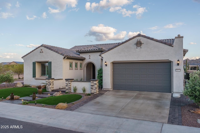 26673 W Ponderosa Ln, Buckeye, AZ 85396 - mediterranean / spanish-style home with stucco siding, driveway, a tile roof, and an attached garage