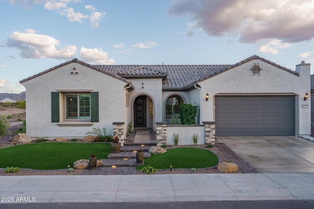 26673 W Ponderosa Ln, Buckeye, AZ 85396 - mediterranean / spanish-style house with stucco siding, an attached garage, a tiled roof, driveway, and a front yard