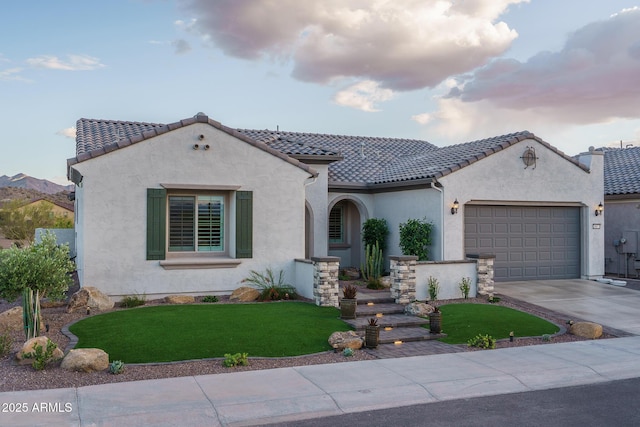 26673 W Ponderosa Ln, Buckeye, AZ 85396 - mediterranean / spanish house featuring a tiled roof, a garage, concrete driveway, and stucco siding