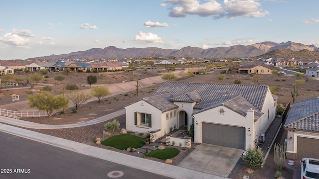 26673 W Ponderosa Ln, Buckeye, AZ 85396 - view of front of house featuring a tiled roof, stucco siding, a mountain view, and an attached garage