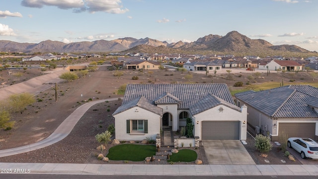 26673 W Ponderosa Ln, Buckeye, AZ 85396 - view of front of house featuring driveway, an attached garage, a tile roof, stucco siding, and a mountain view