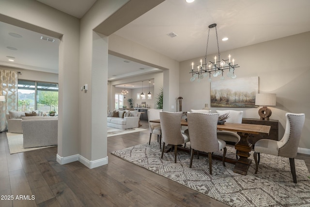 26673 W Ponderosa Ln, Buckeye, AZ 85396 - dining room featuring a notable chandelier, visible vents, and wood-type flooring