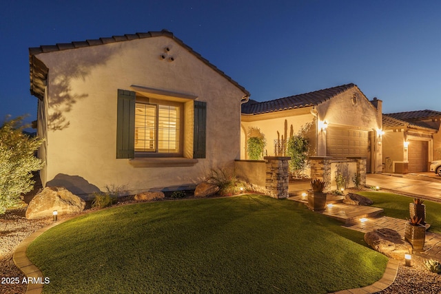 26673 W Ponderosa Ln, Buckeye, AZ 85396 - mediterranean / spanish-style home featuring driveway, stucco siding, an attached garage, a tiled roof, and a yard