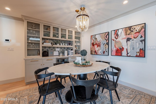 dining area featuring baseboards, an inviting chandelier, and recessed lighting
