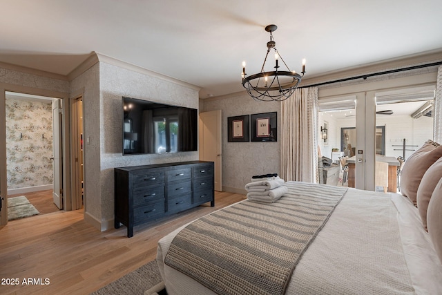 bedroom with light wood finished floors, french doors, baseboards, a notable chandelier, and wallpapered walls