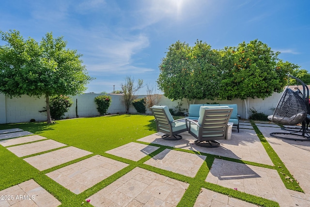 view of yard featuring a fenced backyard, outdoor lounge area, and a patio