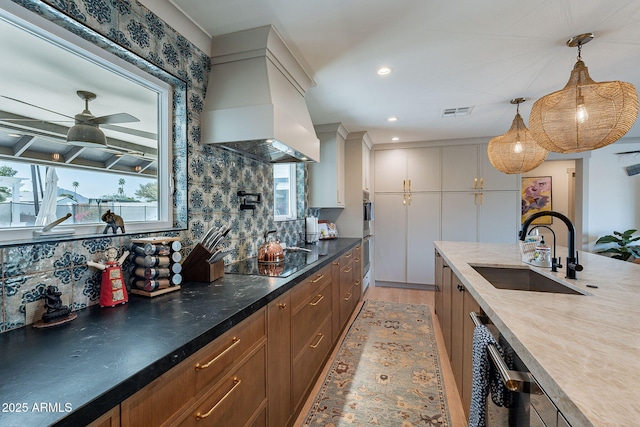 kitchen with black electric stovetop, a sink, custom range hood, and tasteful backsplash